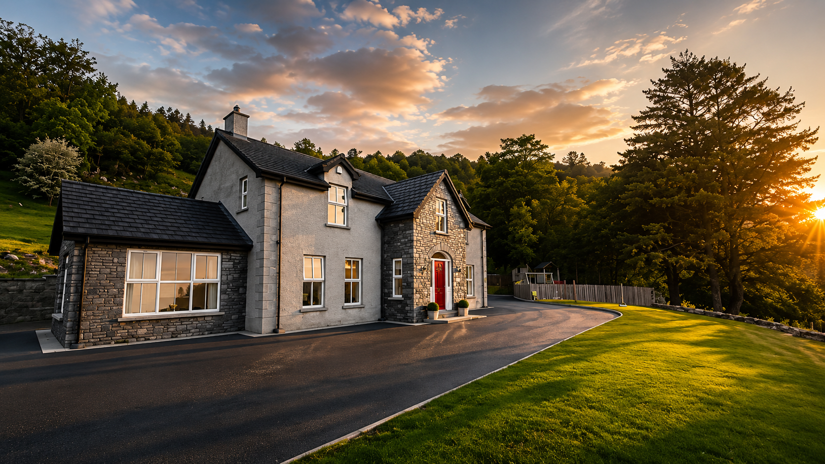 Drumnacross House at golden hour, a beautiful white stone cottage with a bright red front door beneath a spectacular vibrant rainbow and lush green mountains